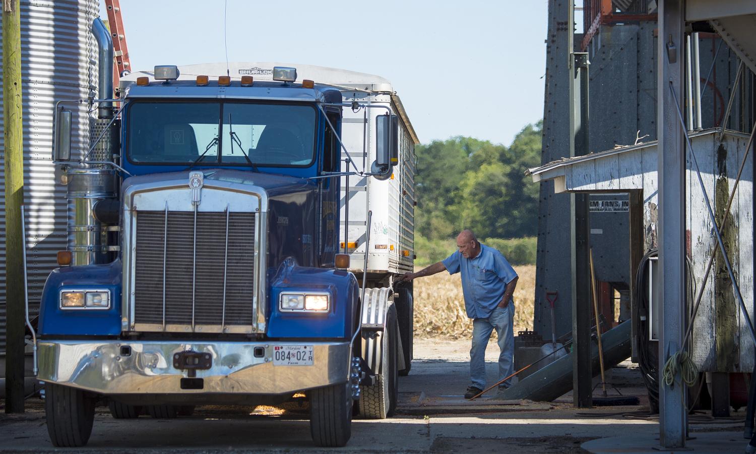 Person working on freight truck.