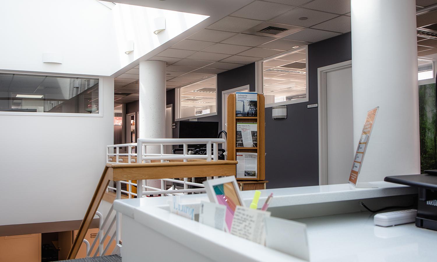 The top floor of an office, lit by a skylight. 