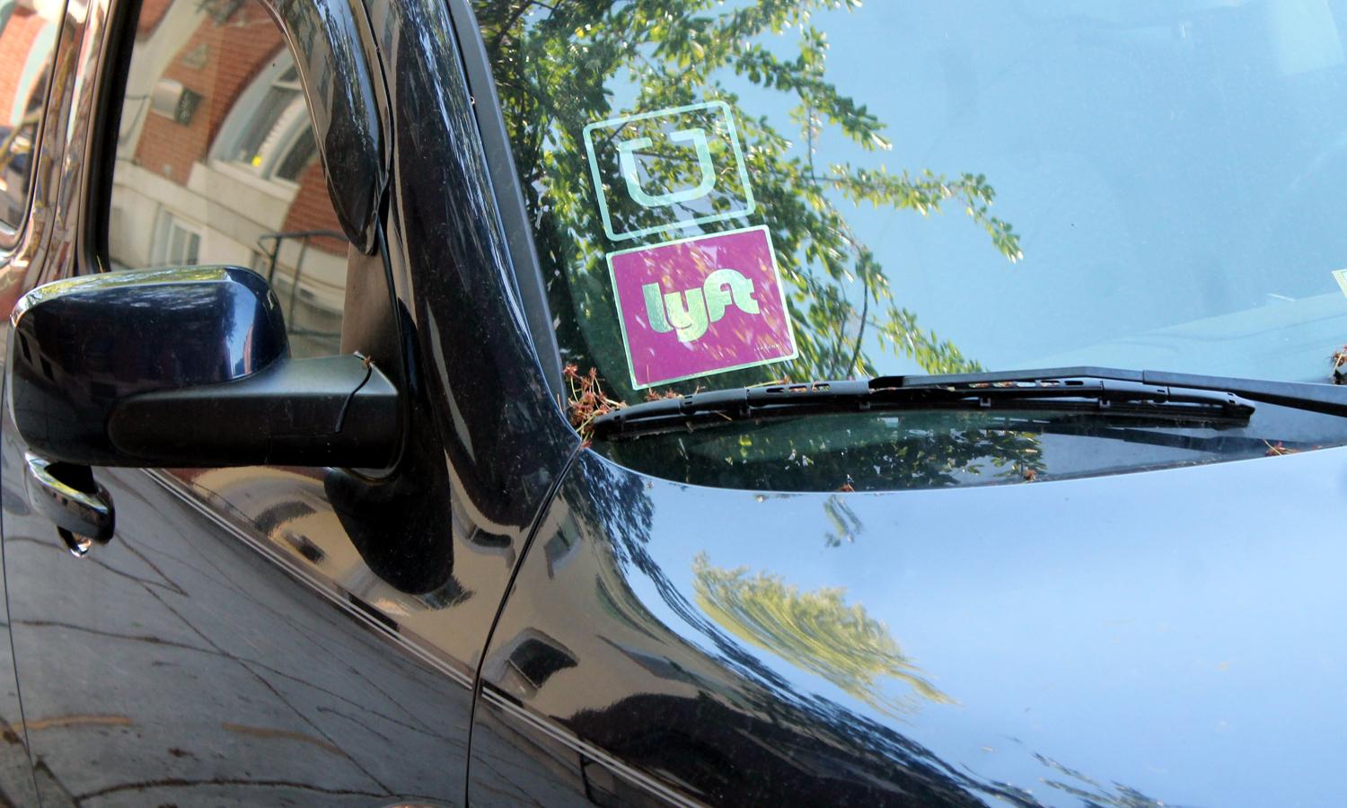 Uber and Lyft stickers in a car window