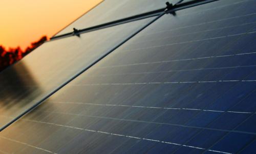 close up of solar panels at sunset