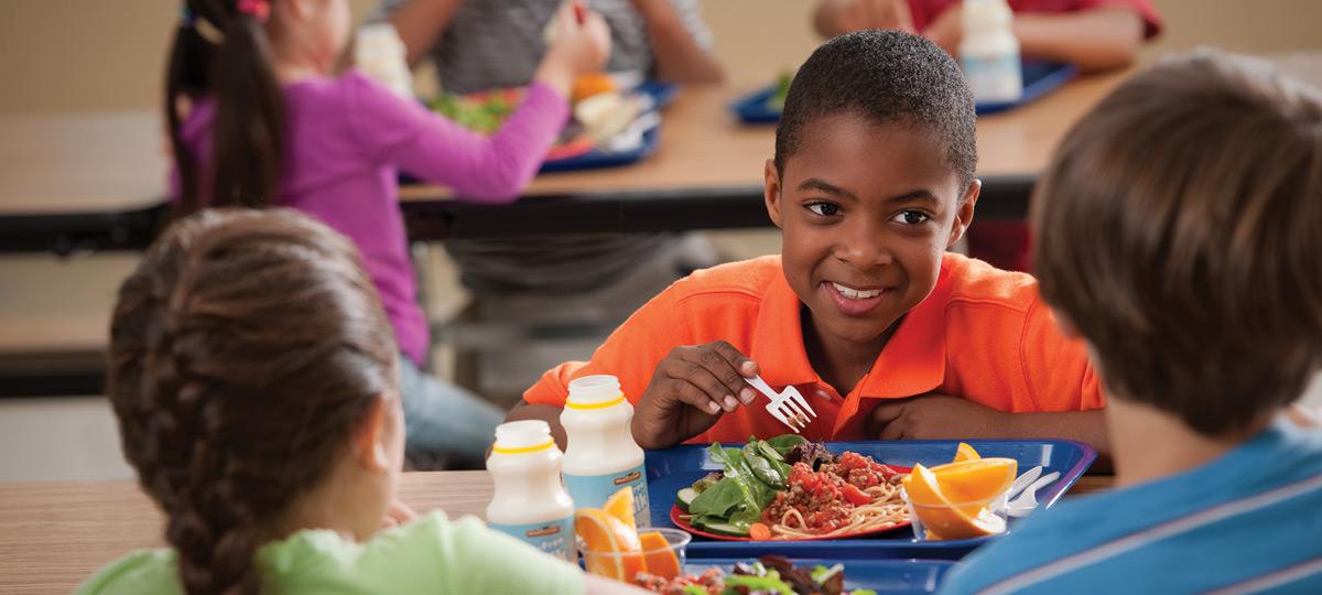 Young kids at a lunch table.