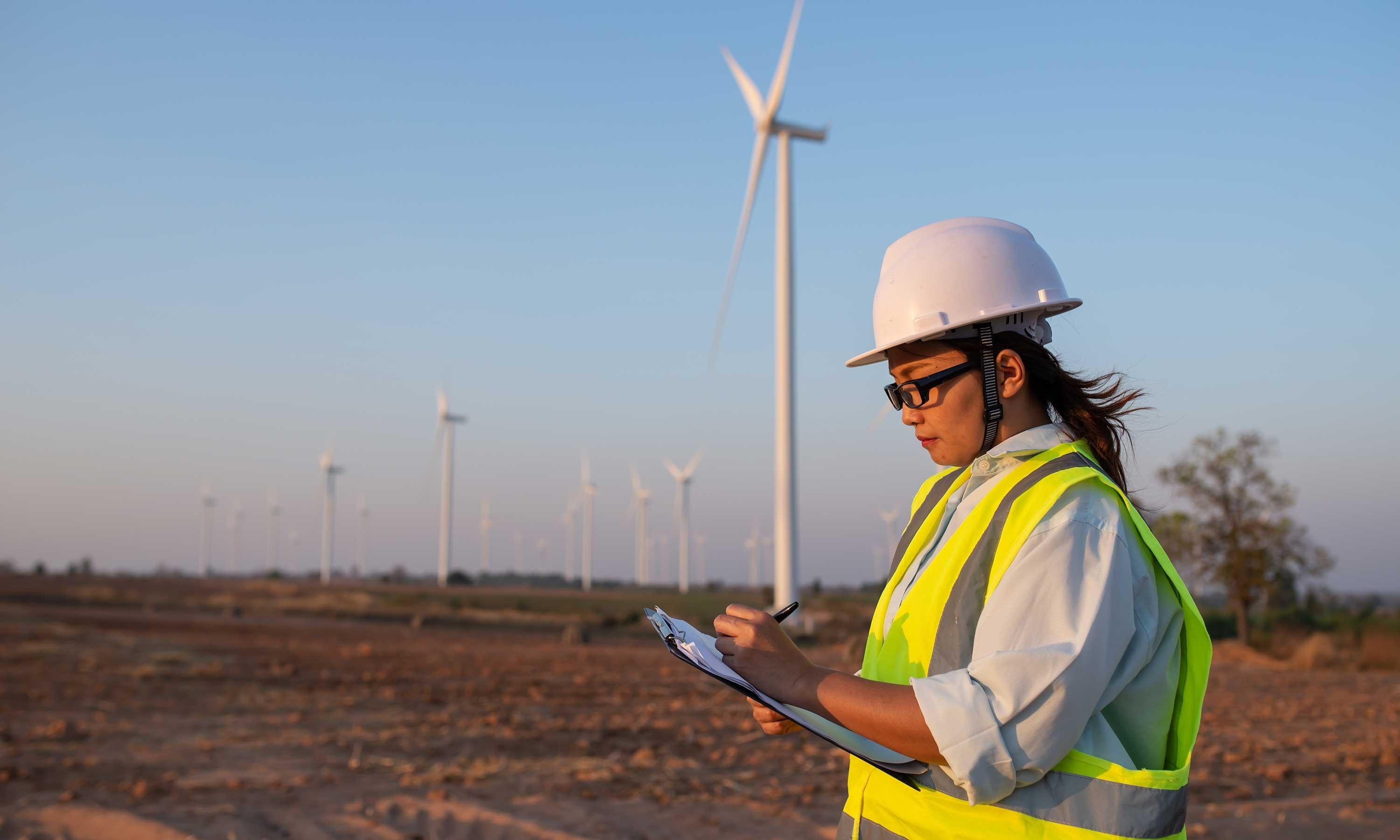 Someone surveying wind turbines