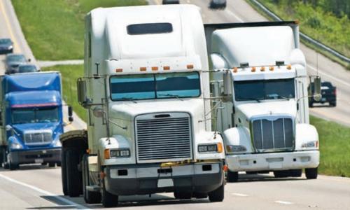 Trucks driving uphill on highway