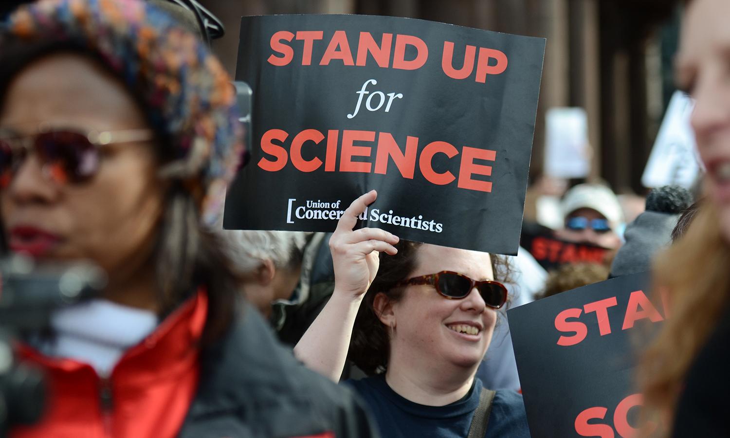 A UCS staff member holding a sign.